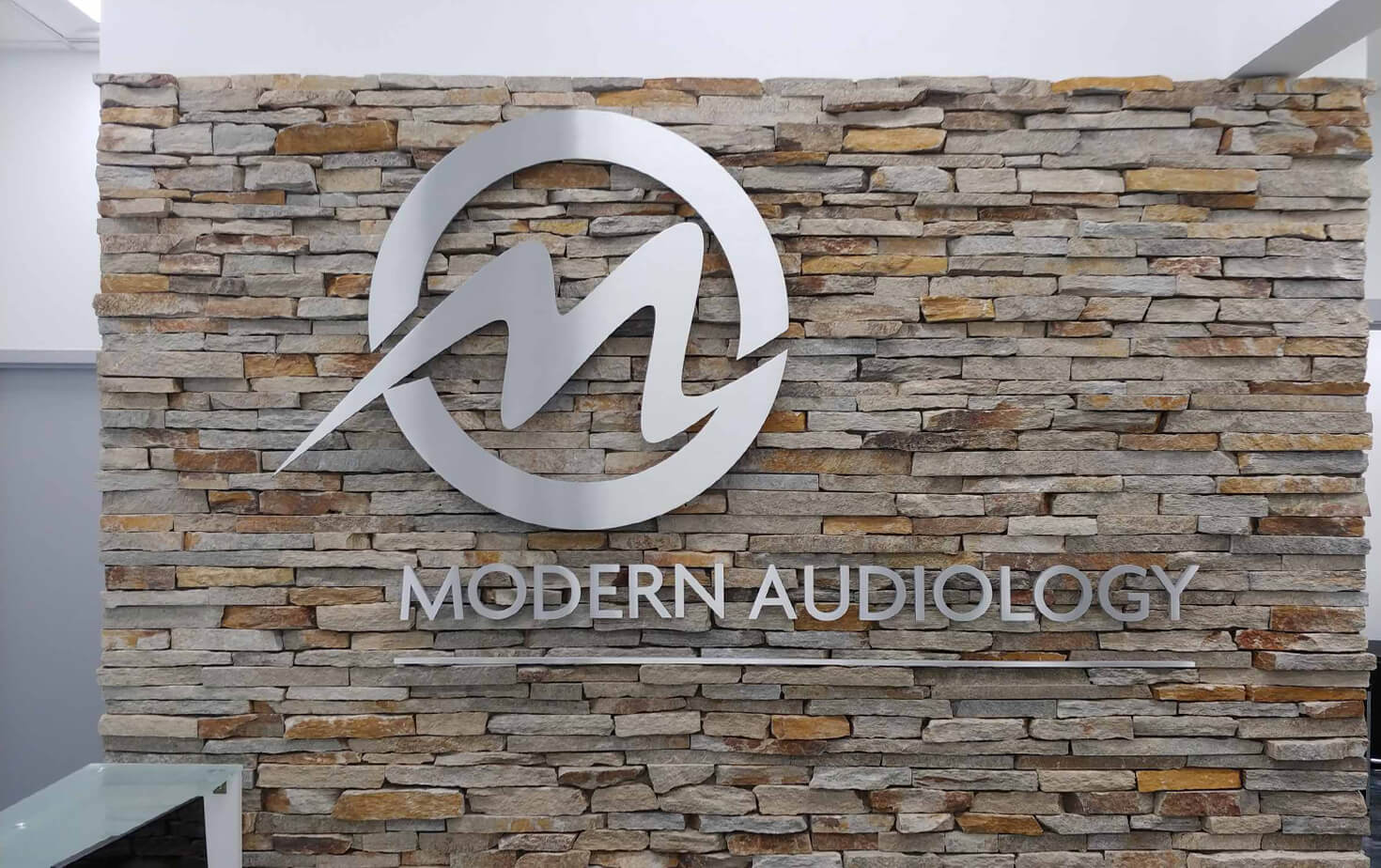 Modern Audiology Richfield MN reception sign on Brick wall