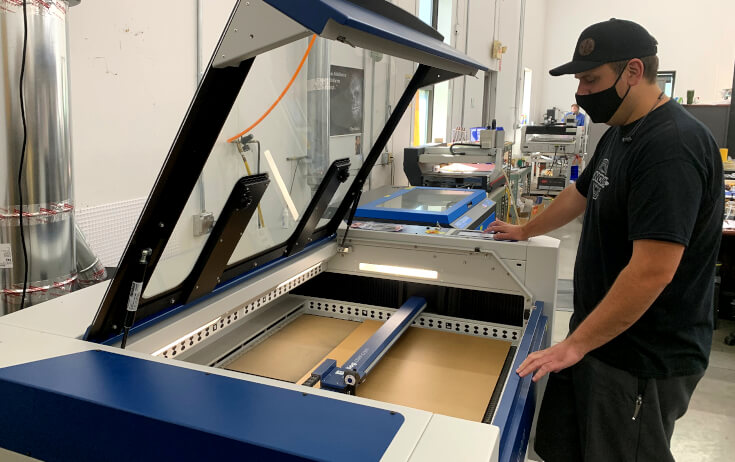 Production Technician Running an engraver making ADA signage in a sign shop