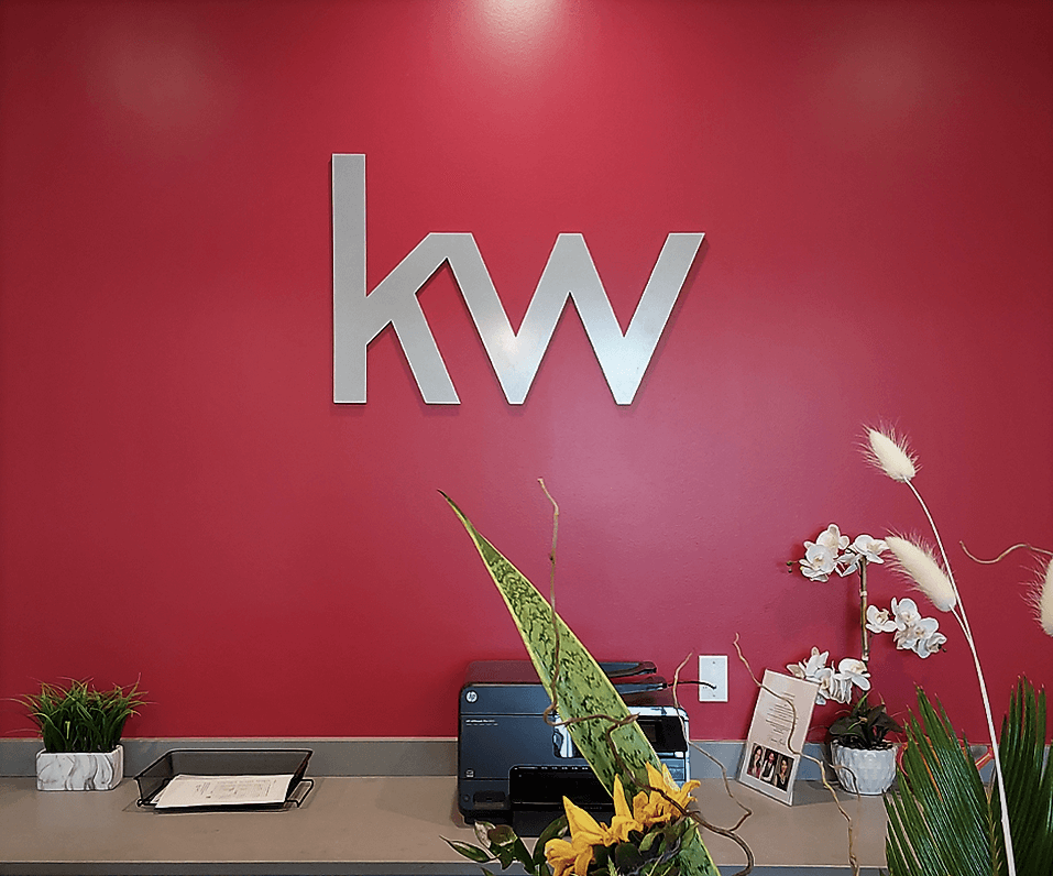 Interior Logo Keller Williams logo on red wall