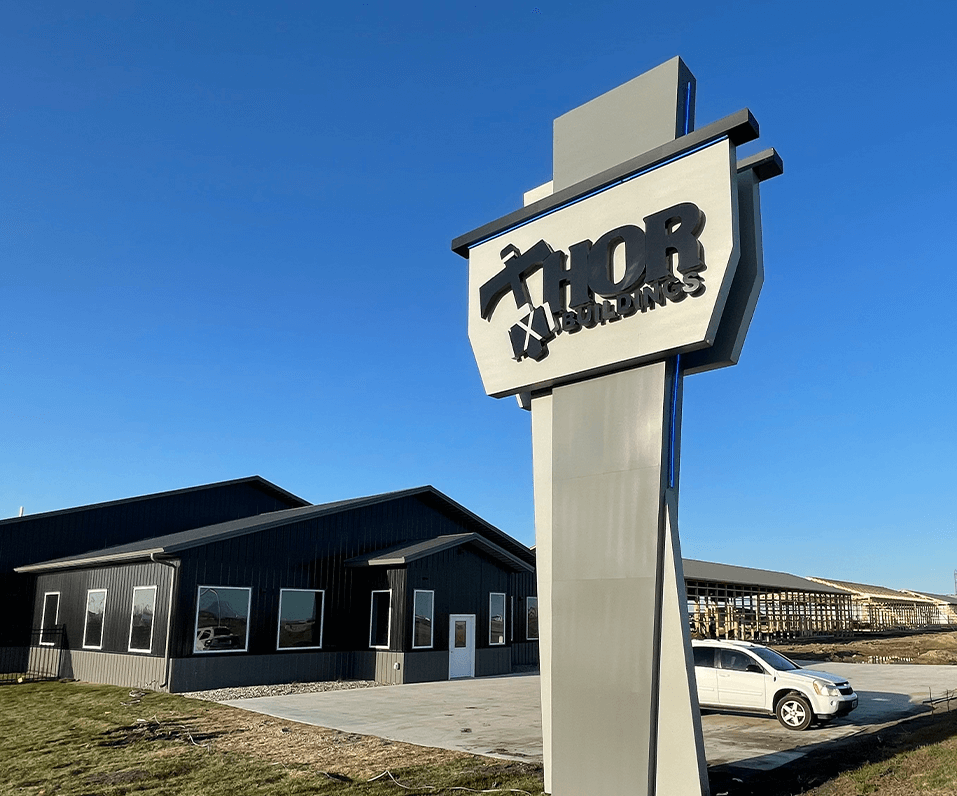 Thor Building Pylon Sign Custom Shaped Cabinet Halo Illuminated Letters and Blue Accent Lighting Fargo ND