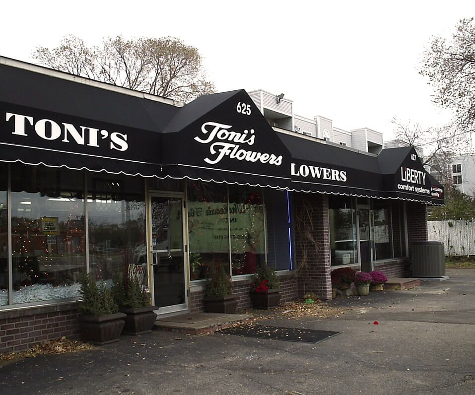 Toni's Flowers black sunbrella awning over storefront